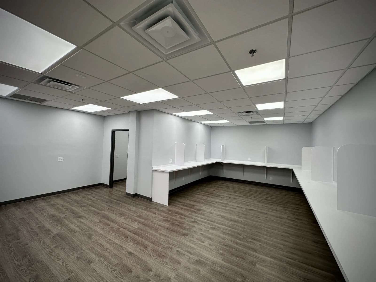Spacious room with overhead lighting